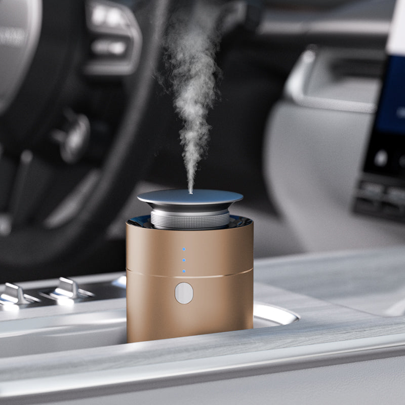 NASS Orbit scent diffuser - matt gold on a car centre console
