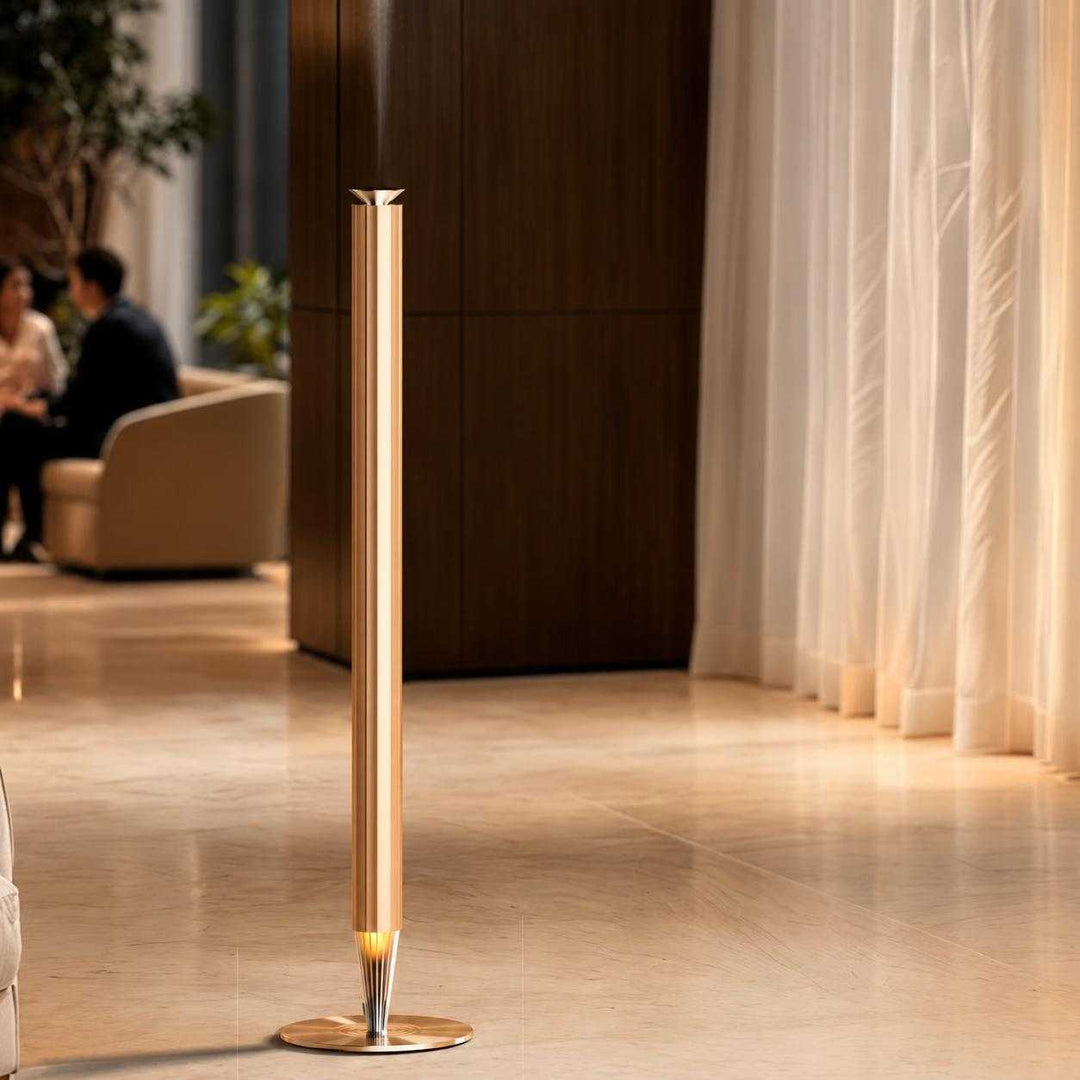 NASS Spire scent diffuser in gold in a hotel lobby